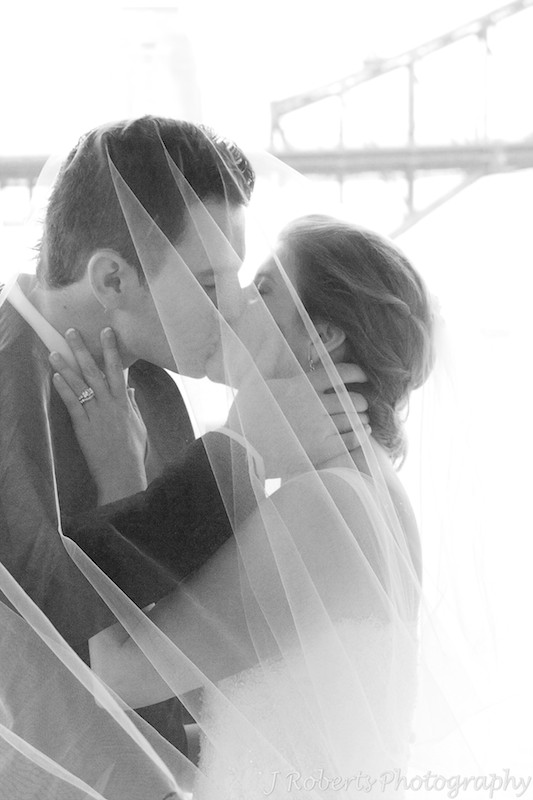 B&W of couple kissing under the veil = wedding photography sydney